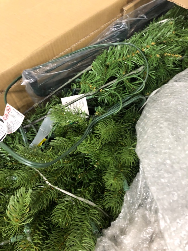 Photo 2 of **USED ITEM**
National Tree Company Pre-Lit 'Feel Real' Artificial Full Downswept Christmas Tree, Green, Douglas Fir, White Lights, Includes Stand, 6.5 feet 6.5 ft