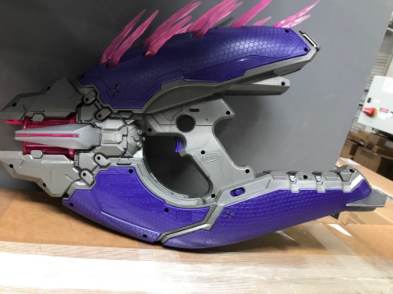 Photo 2 of *** See clerk notes**
NERF LMTD Halo Needler Dart-Firing Blaster, Light-Up Needles, 10-Dart Rotating Drum, 10 Elite Darts, Game Card with in-Game Content