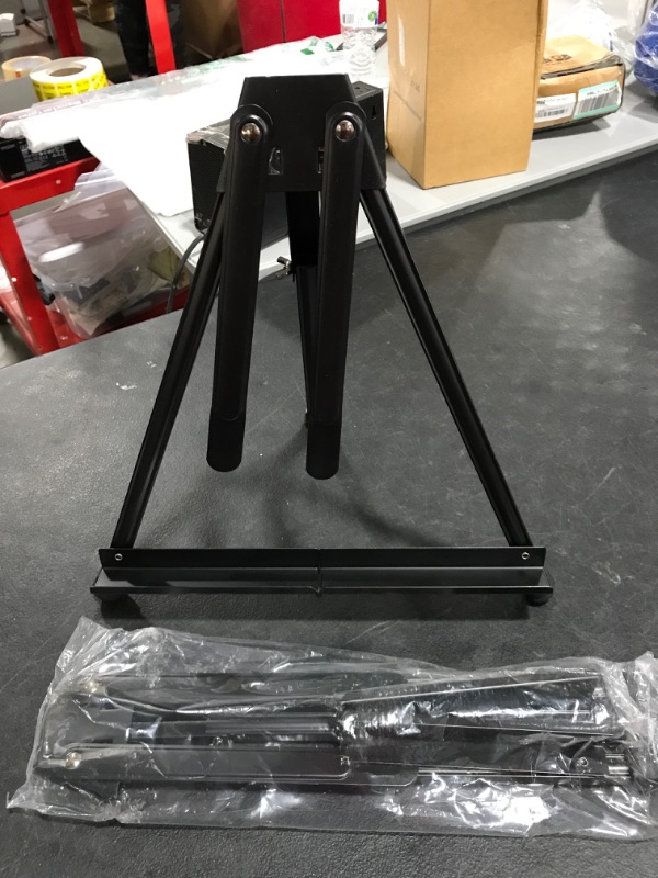 Photo 2 of Aluminum Tabletop Easel, Portable Tripod Display Stand Adjustable Height. LOT OF 2. 
PHOTO FOR REFERENCE. MAY VARY SLIGHTLY. 