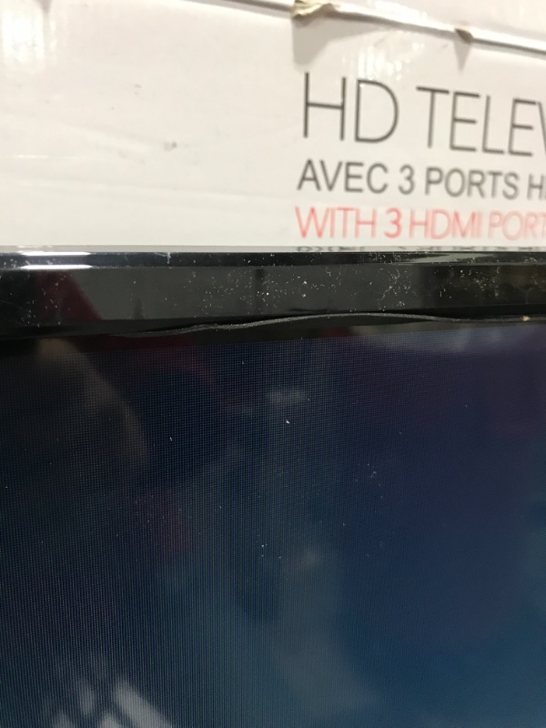 Photo 4 of RCA 32" Class HD (720P) LED TV (RLDED3258A). OPEN BOX. PRIOR USE AS DISPLAY. POWERS ON. FUNCTIONING. DAMAGE AT TOP FRONT EDGE. INCLUDES REMOTE & STAND. 
