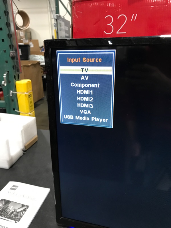 Photo 1 of RCA 32" Class HD (720P) LED TV (RLDED3258A). OPEN BOX. PRIOR USE AS DISPLAY. POWERS ON. FUNCTIONING. DAMAGE AT TOP FRONT EDGE. INCLUDES REMOTE & STAND. 
