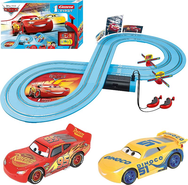 Photo 1 of Carrera First Disney/Pixar Cars - Slot Car Race Track - Includes 2 Cars: Lightning McQueen and Dinoco Cruz - Battery-Powered Beginner Racing Set for Kids Ages 3 Years and Up
