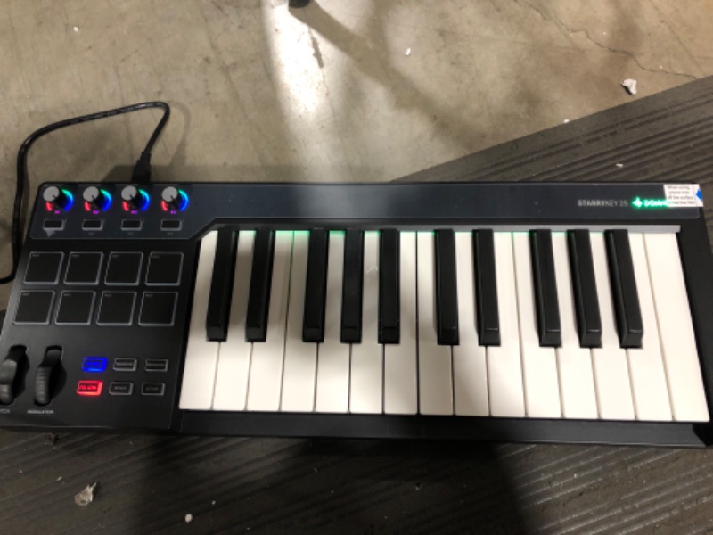 Photo 2 of Donner STARRYKEY MIDI Keyboard MIDI Controller, Full Size 25 keys, 7 Colors Lighting Effect, 8 Velocity-sensitive Backlit Pads with 24 Selectable Custom Tones, with MIDI out and Pedal interface
