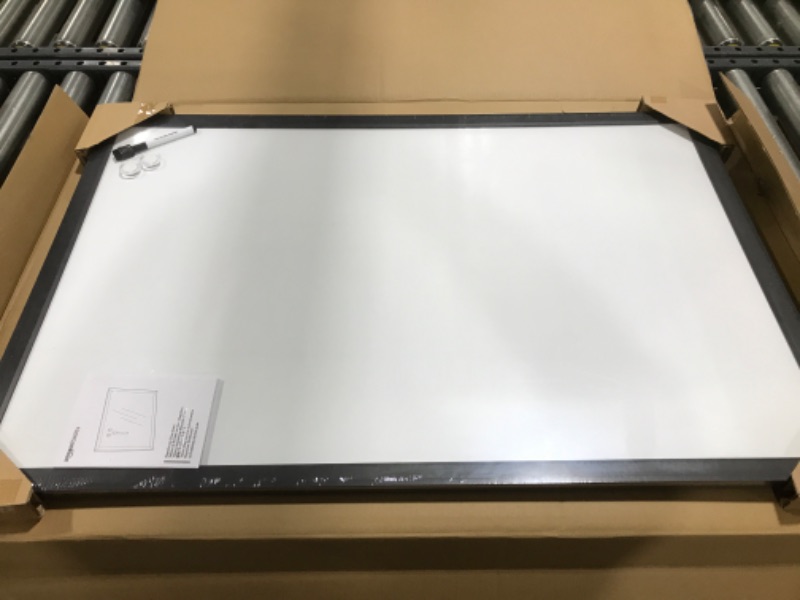 Photo 2 of Amazon Basics Magnetic Dry Erase White Board, 35 x 23-Inch Whiteboard - Black Wooden Frame 23"x35" Magnetic, Wood Frame