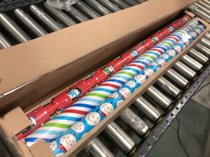 Photo 2 of  American Greetings Christmas Reversible Wrapping Paper, Blue Snowman, Red Penguin and Multicolor Stripe, 3-Rolls, 120 Total Sq. Ft. 