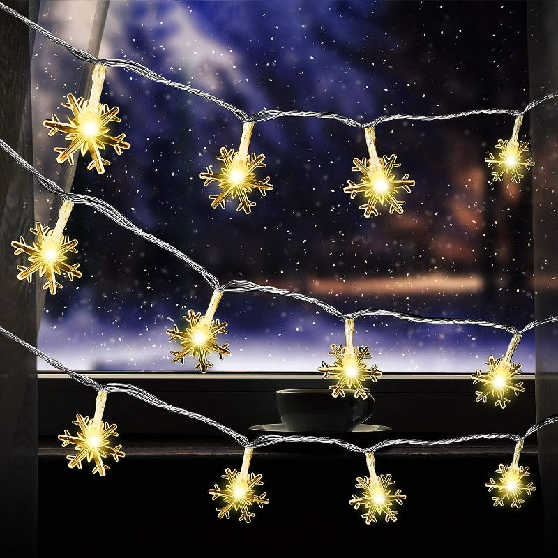 Photo 1 of Aneco 60 LED Fairy Lights 30 Feet Warm White Snowflake Shaped String Light with Waterproof Window Curtain String Light for Christmas Wall Garden Indoor Outdoor Decor
