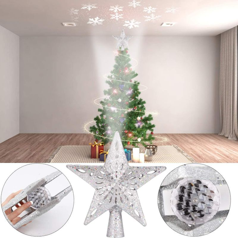 Photo 2 of Christmas Tree Topper Lighted Star [Silver],3D Hollow Sparkling Star Christmas Tree Topper with Rotating Magic Cool White Snowflake Projector for Christmas Tree Ornament (Silver)
