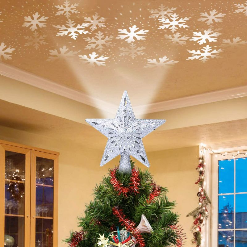 Photo 1 of Christmas Tree Topper Lighted Star [Silver],3D Hollow Sparkling Star Christmas Tree Topper with Rotating Magic Cool White Snowflake Projector for Christmas Tree Ornament (Silver)
