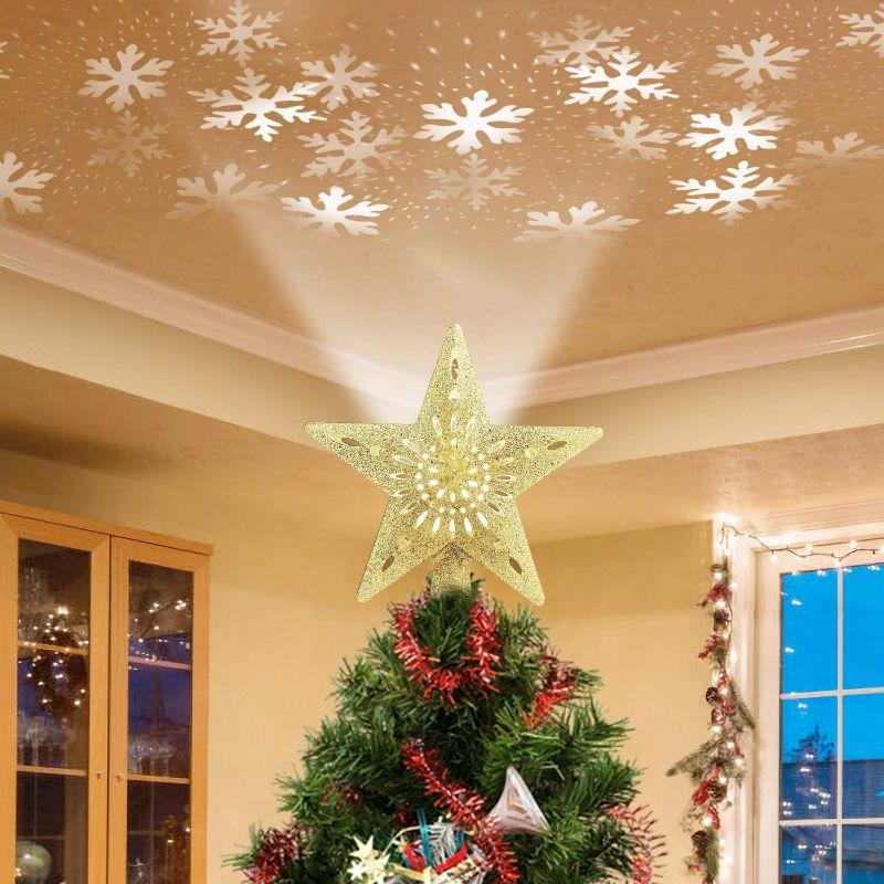 Photo 1 of Christmas Tree Topper Lighted Star [Gold],3D Hollow Sparkling Star Christmas Tree Topper with Rotating Magic Cool White Snowflake Projector for Christmas Tree Ornament (Gold)
