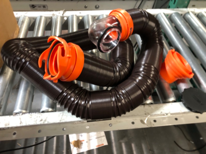 Photo 1 of Camco RhinoFLEX RV Sewer Hose Kit with Swivel Transparent Elbow and 4-in-1 Dump Station Fitting, Brown, 15 Feet (39770) 15ft Sewer Hose Kit Frustration-Free Packaging