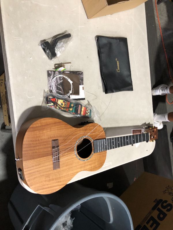 Photo 2 of ***ACCESSORIES MISSING - STRINGS DAMAGED - SEE PICTURES***
Caramel CB207 Acacia Baritone Acoustic Electric Ukulele with Truss Rod