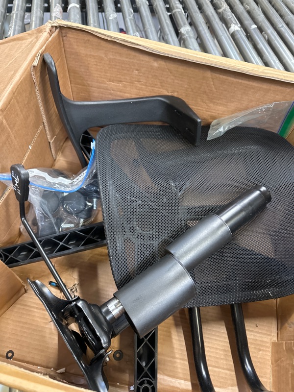 Photo 3 of Amazon Basics Mesh, Mid-Back, Adjustable, Swivel Office Desk Chair with Armrests, Black -- possibly missing some of the screws due to it being loose inside the box 