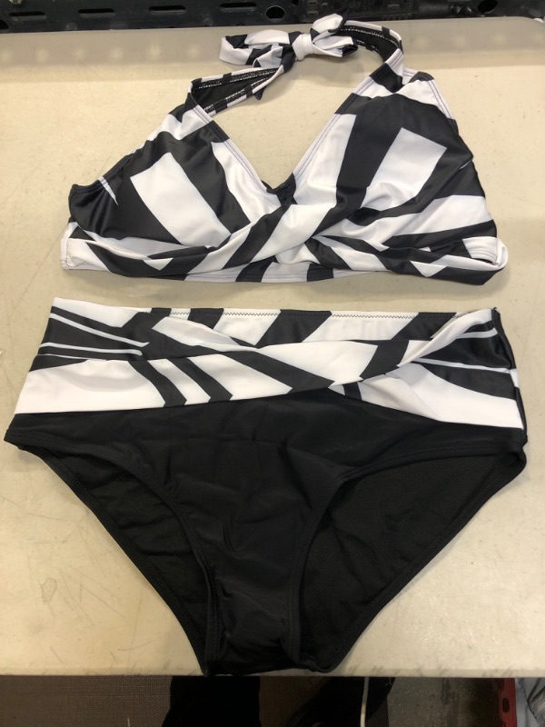 Photo 1 of 
TWO PIECE BLACK AND WHITE BATHING SUIT SIZE XL 