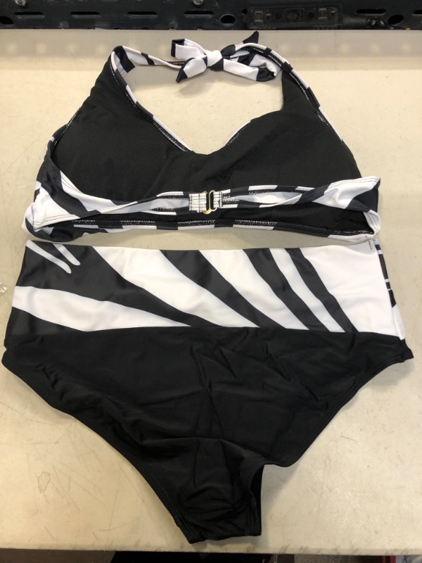 Photo 2 of 
TWO PIECE BLACK AND WHITE BATHING SUIT SIZE XL 