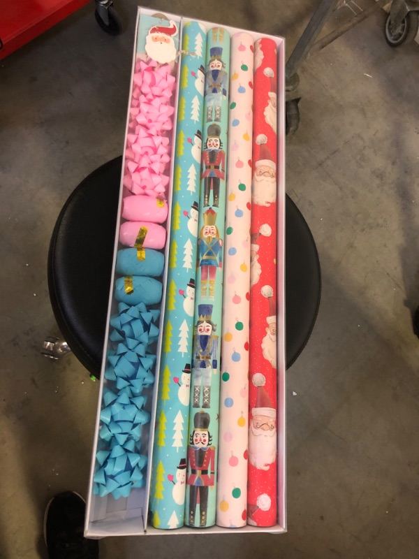 Photo 2 of (3 Pack) Wrapping Paper, Christmas Wrapping Paper for Kids Boys, Girls, baby. 4 Cute Designs Including Santa, Christmas Lights, Snowman, Nutcracker. Includes Decorative Flowers, Ribbons, Labels. Each Roll of Gift Wrap Paper Measures 27.5 In X 13 ft