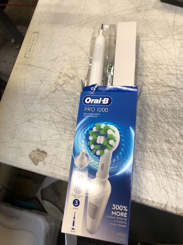 Photo 2 of Oral-B Pro 1000 Power Rechargeable Electric Toothbrush Powered by Braun ,1 count , White (Packaging may vary) White 1 Count (Pack of 1)