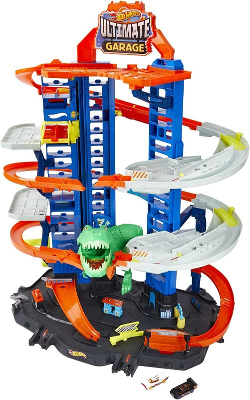 Photo 1 of Hot Wheels Ultimate Garage Track Set with 2 Toy Cars, Hot Wheels City Playset with Multi-Level Side-by-Side Racetrack, Moving T-Rex Dino & Hot Wheels Storage for 100+ 1:64 Scale Vehicles
