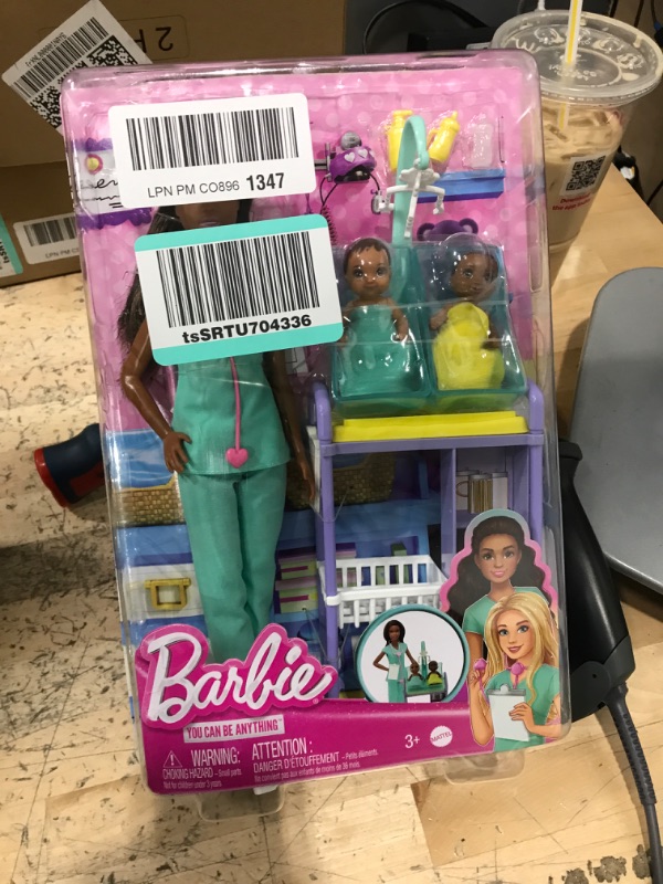 Photo 2 of Barbie Baby Doctor Playset with Brunette Doll, 2 Infant Dolls, Exam Table and Accessories, Stethoscope, Chart and Mobile for Ages 3 and Up