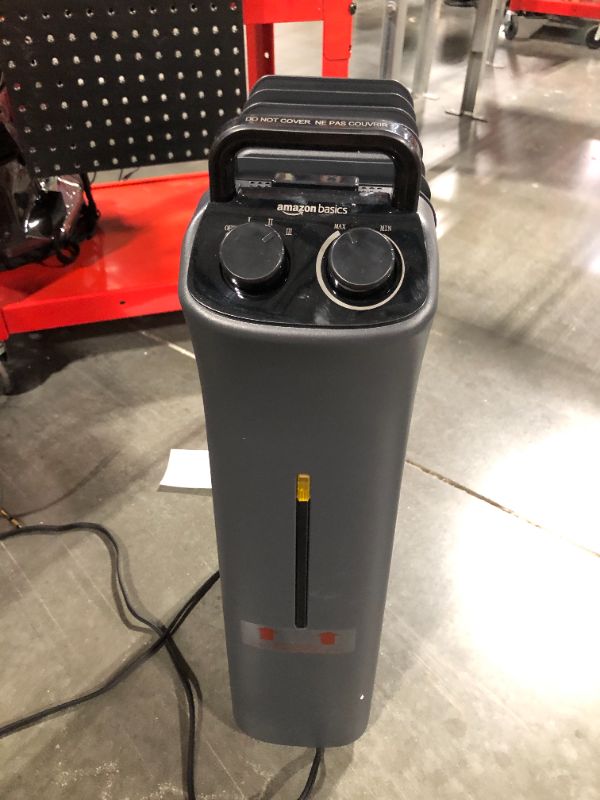 Photo 1 of Amazon Basics Portable Radiator Heater with 7 Wavy Fins, Manual Control, Black, 1500W