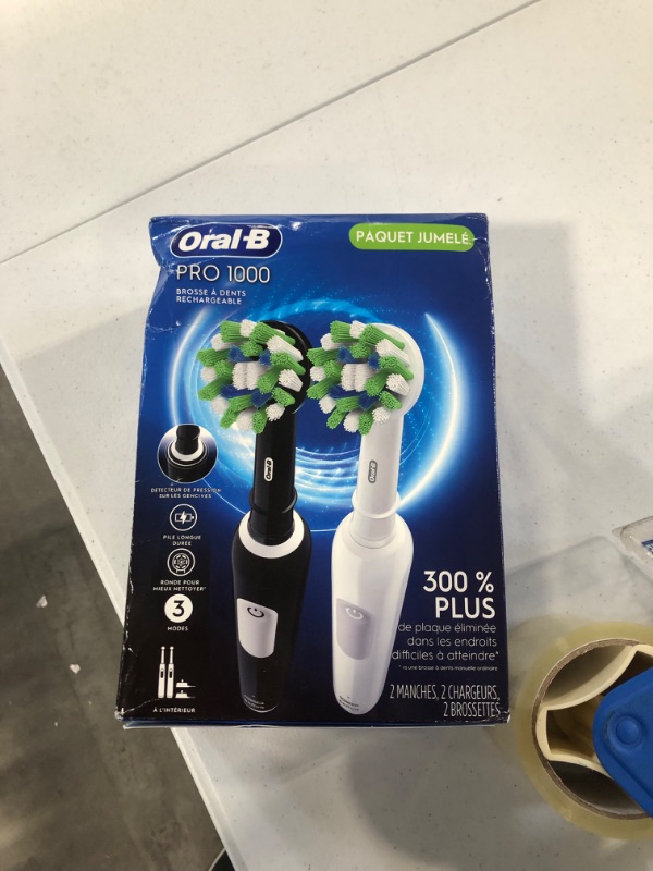 Photo 2 of Oral-B Pro 1000 CrossAction Electric Toothbrush, Black and White, 2 Count Black & White 2 Rechargeable Handles