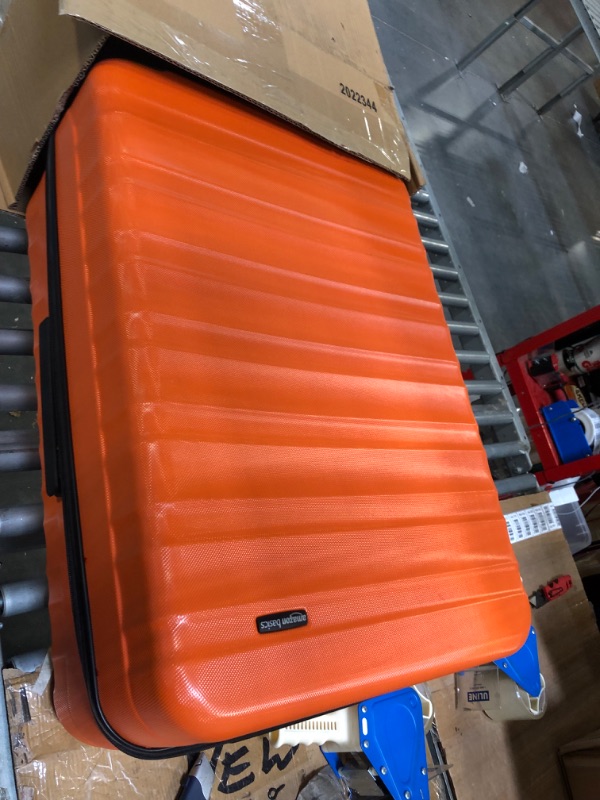 Photo 1 of Amazon Basics 30-Inch Hardside Spinner, Orange Orange 30-inch Spinner