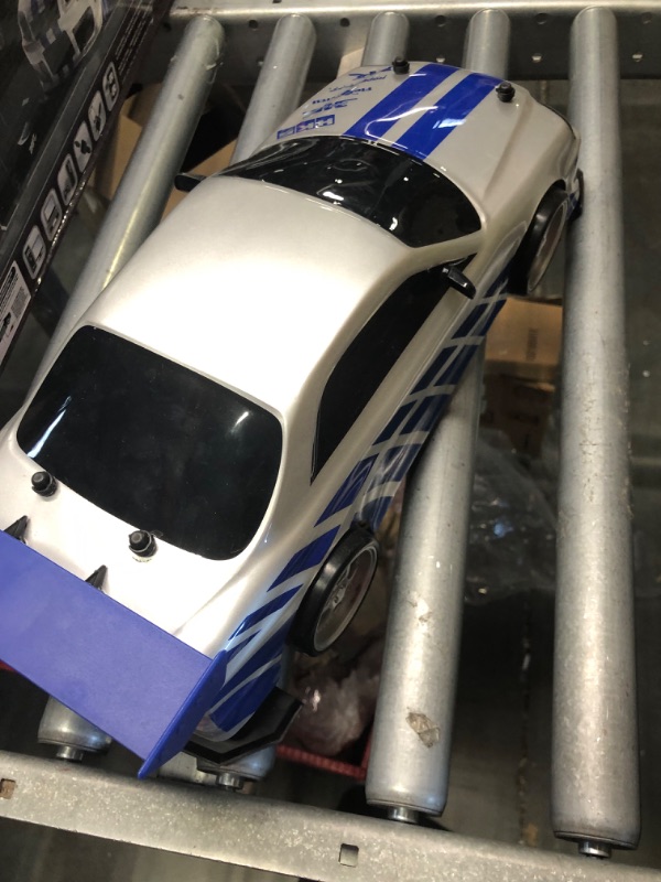 Photo 5 of Jada Toys Fast & Furious Brian's Nissan Skyline GT-R (BN34) Drift Power Slide RC Radio Remote Control Toy Race Car with Extra Tires, 1:10 Scale, Silver/Blue (99701)