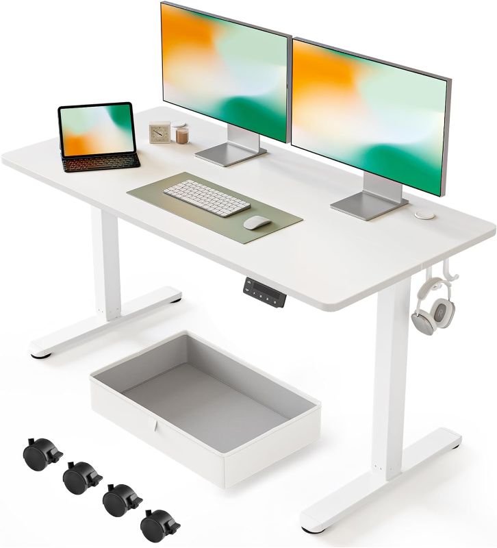 Photo 1 of FEZIBO 55 x 24 Inches Standing Desk with Drawer, Adjustable Height Electric Stand up Desk, Sit Stand Home Office Desk, Ergonomic Workstation White Steel Frame/White Tabletop
