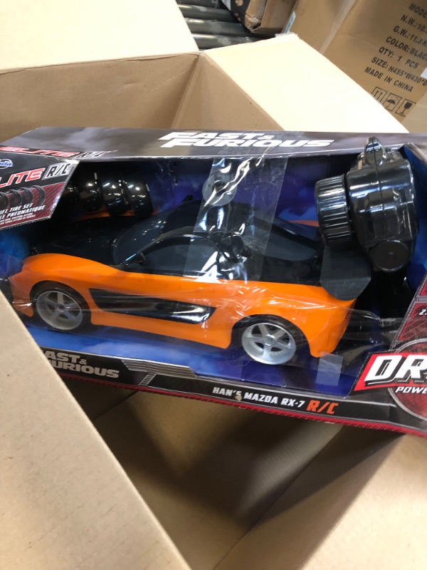 Photo 2 of Jada Toys Fast & Furious Han’s Mazda RX-7 Drift RC Car, 1: 10 Scale 2.4Ghz Remote Control Orange & Black, Ready to Run, USB Charging (Standard) (99700)