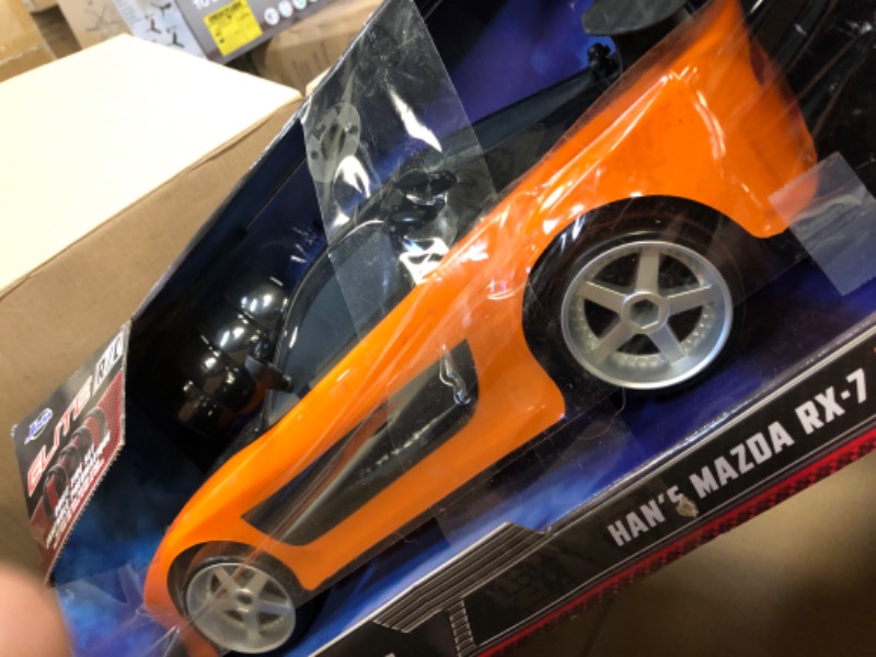 Photo 3 of Jada Toys Fast & Furious Han’s Mazda RX-7 Drift RC Car, 1: 10 Scale 2.4Ghz Remote Control Orange & Black, Ready to Run, USB Charging (Standard) (99700)