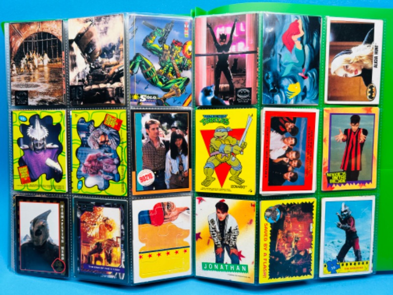 Photo 1 of 698681…180 mixed character and comic trading cards in binder