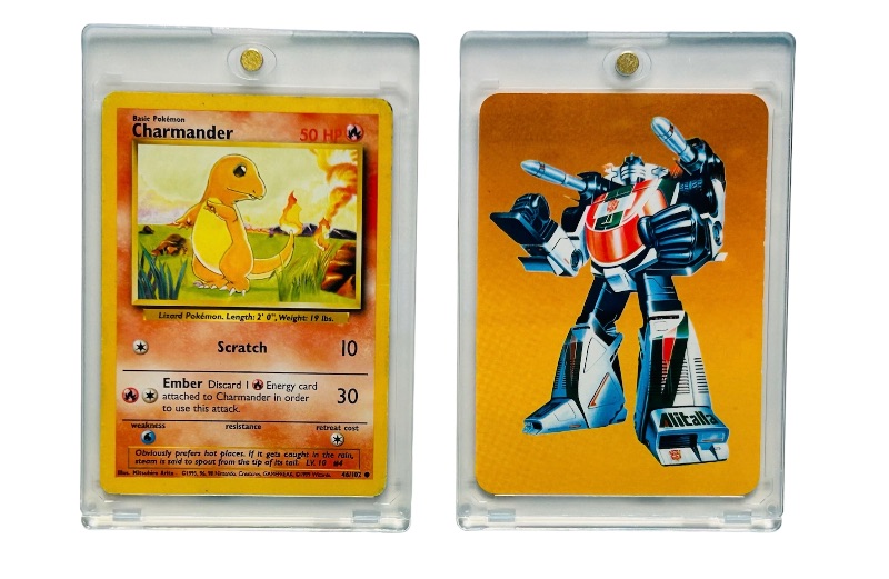 Photo 1 of 698724…Pokémon and Transformers cards in hard plastic cases  Charmander and Wheeljack 