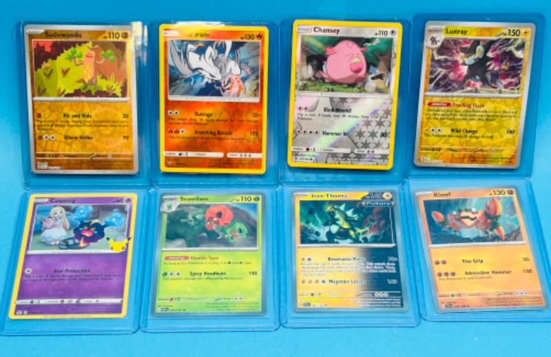 Photo 1 of 698940…8 holo and reverse holo Pokémon cards in hard plastic sleeves 