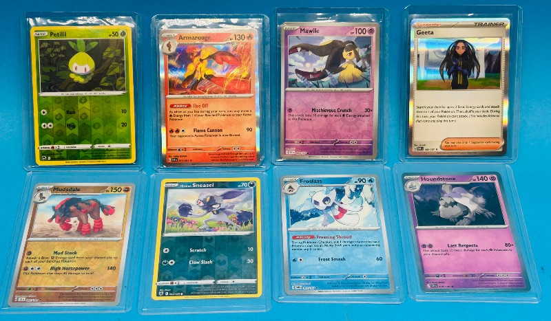 Photo 1 of 699472… 8 reverse and holo Pokémon cards in hard plastic sleeves 