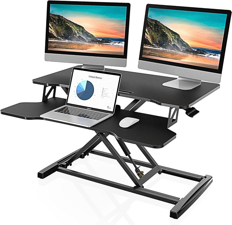 Photo 1 of FITUEYES Height Adjustable Standing Desk 32” Wide Sit to Stand Converter Stand Up Desk Tabletop Workstation for Laptops Dual Monitor Riser Black SD308001WB
