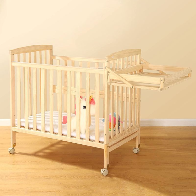 Photo 1 of FUNLIO 4 In 1 Convertible Mini Baby Crib With Changing Table & Wheels, Paint Free Pine Wood Crib For Small Spaces
