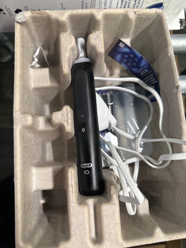 Photo 1 of Oral-B iO Series 5 Limited Electric Toothbrush with (3) Brush Head, Rechargeable, Black Black 1 Count (Pack of 1)