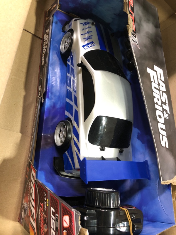 Photo 2 of Jada Toys Fast & Furious Brian's Nissan Skyline GT-R (BN34) Drift Power Slide RC Radio Remote Control Toy Race Car with Extra Tires, 1:10 Scale, Silver/Blue (99701)