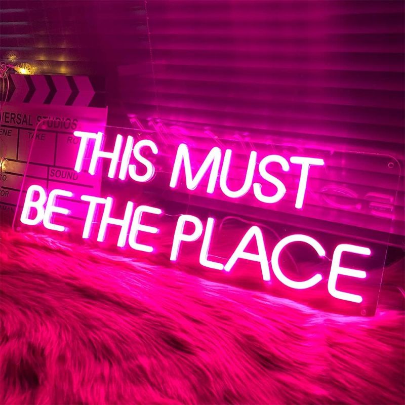 Photo 1 of This Must Be The Place Neon Signs for Bedroom Wall Decor LED Light Up Signs Girl Room Decor Large Pink Neon Light Sign Words Lights Beer Bar Club Windows Hotel Pub Cafe Wedding Birthday Party Decoration Gifts 24x8"
