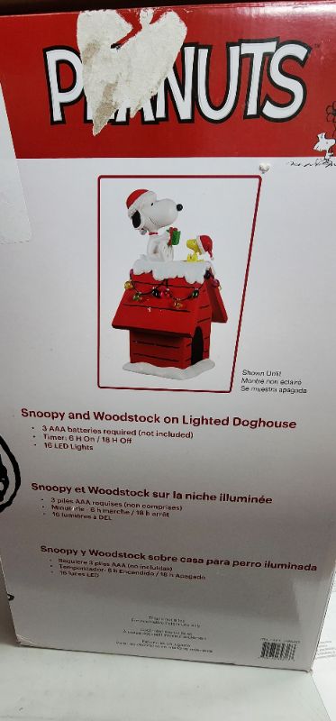 Photo 2 of 19" Peanuts Snoopy & Woodstock Holiday Dog House. For Indoor Decorative Use Only. The beloved Peanuts characters, Snoopy & Woodstock, have become synonymous with the Holidays since their debut over 70 years ago. Bring the magic of these cherished characte