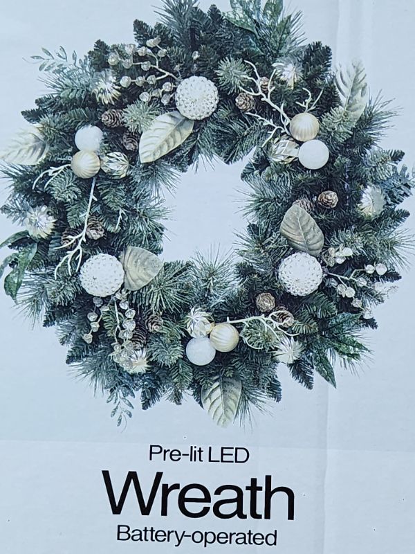 Photo 1 of COSTCO The Pre-Lit Battery Operated 32-Inch Wreath with Dual Color LED Lights Pinecones Leaves features branch tips that are molded from real tree branches for an authentic appearance.