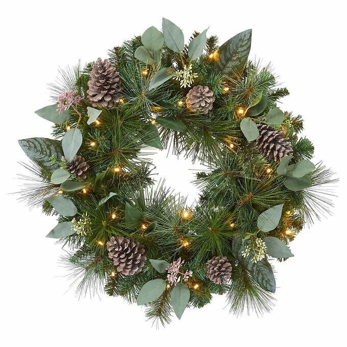 Photo 1 of 24" Pre-Lit Artificial Mixed Greenery Wreath. Make your entrance merry with this lush, beautiful holiday wreath. Resembling a fresh mix of Scotch pine, magnolia, and pear leaves, all accented with white-washed pinecones and faux eucalyptus. This wreath ha