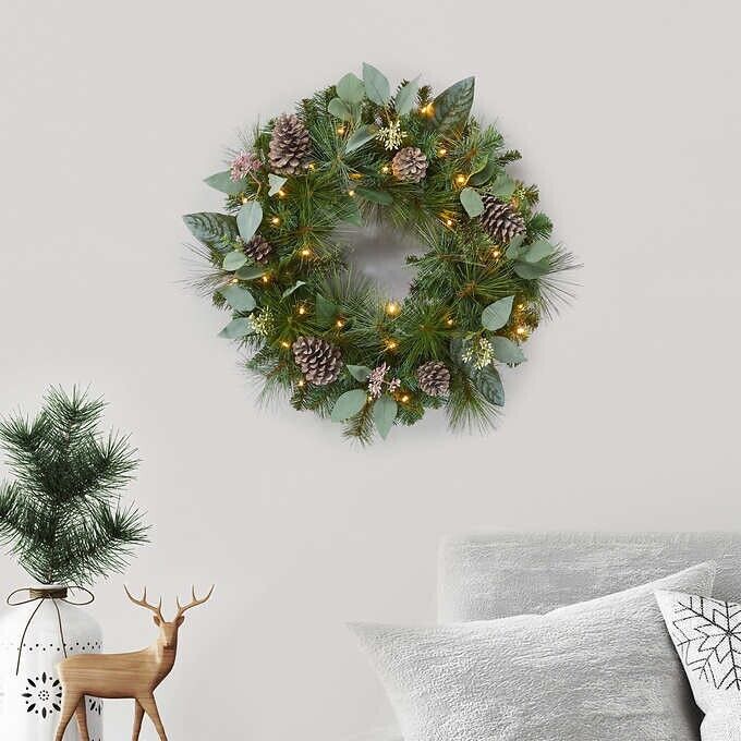 Photo 4 of 24" Pre-Lit Artificial Mixed Greenery Wreath. Make your entrance merry with this lush, beautiful holiday wreath. Resembling a fresh mix of Scotch pine, magnolia, and pear leaves, all accented with white-washed pinecones and faux eucalyptus. This wreath ha