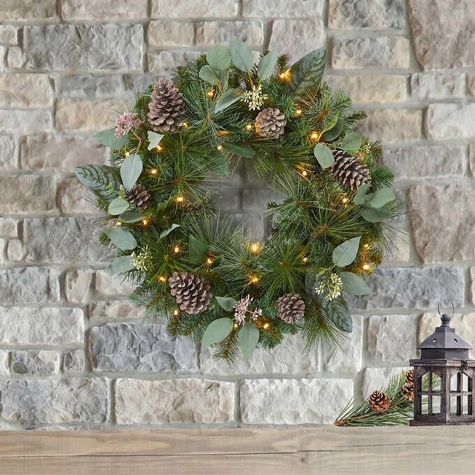 Photo 3 of 24" Pre-Lit Artificial Mixed Greenery Wreath. Make your entrance merry with this lush, beautiful holiday wreath. Resembling a fresh mix of Scotch pine, magnolia, and pear leaves, all accented with white-washed pinecones and faux eucalyptus. This wreath ha