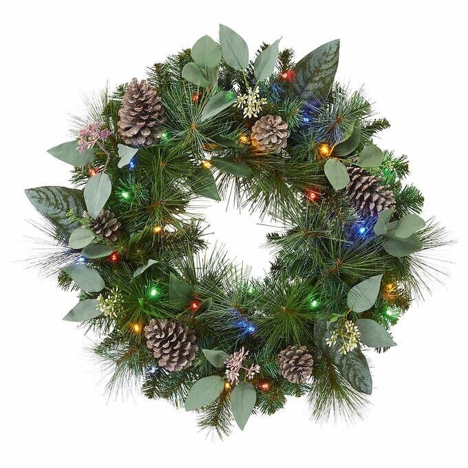 Photo 2 of 24" Pre-Lit Artificial Mixed Greenery Wreath. Make your entrance merry with this lush, beautiful holiday wreath. Resembling a fresh mix of Scotch pine, magnolia, and pear leaves, all accented with white-washed pinecones and faux eucalyptus. This wreath ha