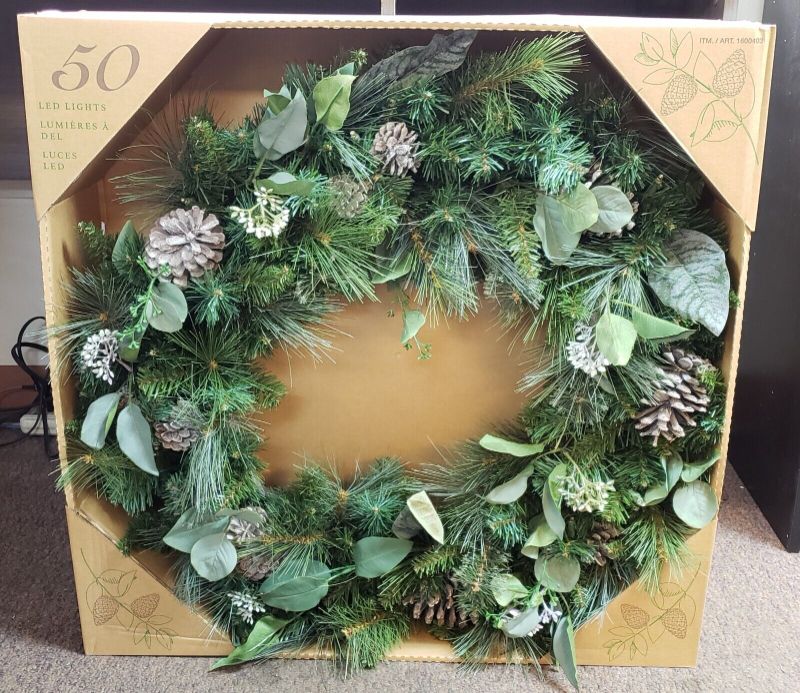 Photo 1 of COSTCO 50 LED LIGHTS DUAL COLOR PRE LIT BATTERY OPERATED WREATH 32". The Pre-Lit Battery Operated 32-Inch Wreath with Dual Color LED Lights Pinecones Leaves features branch tips that are molded from real tree branches for an authentic appearance. This mix