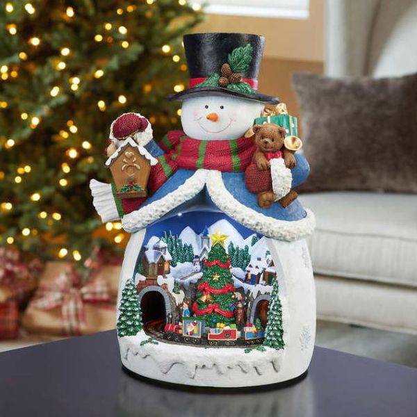 Photo 2 of Moments in Time Christmas Decor Snowman with Christmas Village Scene, with LED Lights, Christmas Music, and Animation - Power Adapter (Included)
(18.7" H x 11.4" W x 12.8" D). Plays 8 Classic Christmas Songs: We Wish You A Merry Christmas; O Christmas Tre