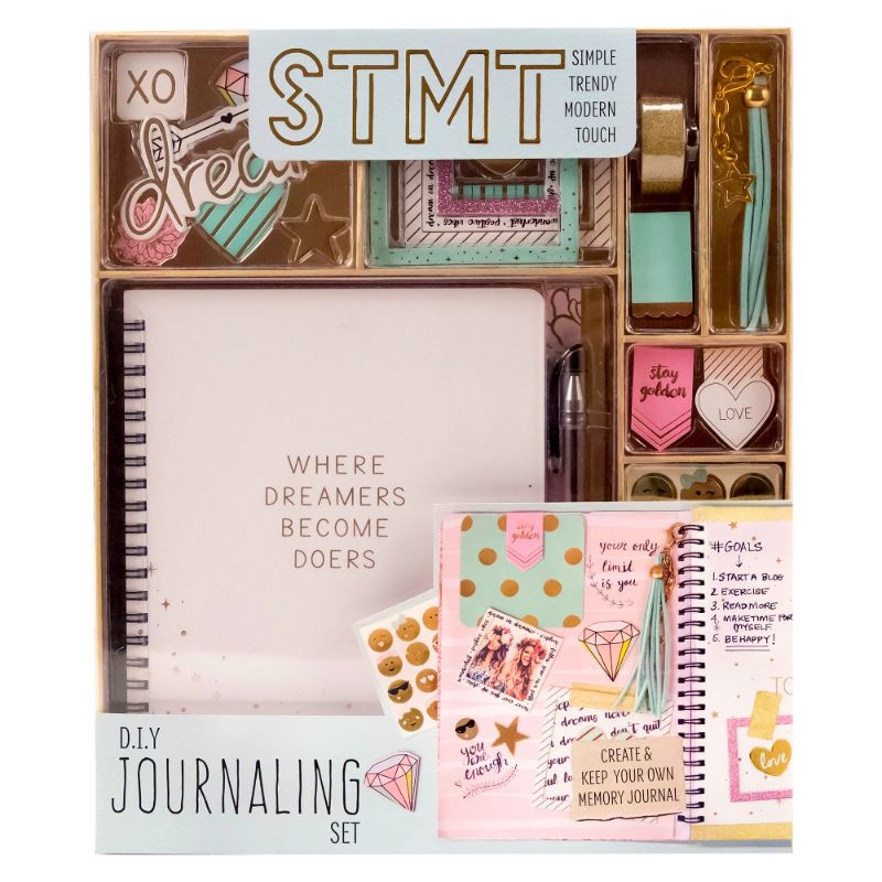 Photo 1 of STMT DIY Journaling Set. Let her express herself with this DIY journaling kit by STMT. Kit includes 1 journal with 70 sheets, 8 die cut shapes, 1 sticker sheet, 1 roll of glitter tape, 1 ball point pen, 6 shaped paper clips, 3 magnetic folded bookmarks, 5
