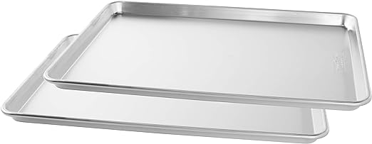 Photo 1 of Nordic Ware Naturals Big Baking Sheet, 2 Pack, Silver. Naturals commercial bakeware is made of pure aluminum foods bake and brown evenly due to aluminum’s superior heat conductivity. Reinforced encapsulated steel rim prevents warping and adds strength. Ea