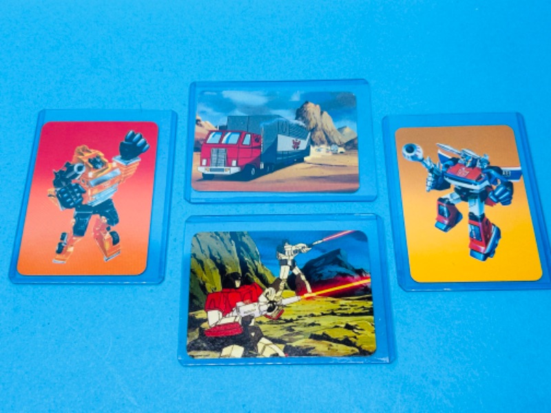 Photo 1 of 811457… 4 vintage 1985 transformers series 1 cards in hard plastic sleeves 