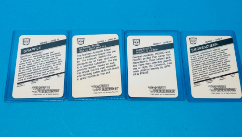 Photo 2 of 811457… 4 vintage 1985 transformers series 1 cards in hard plastic sleeves 